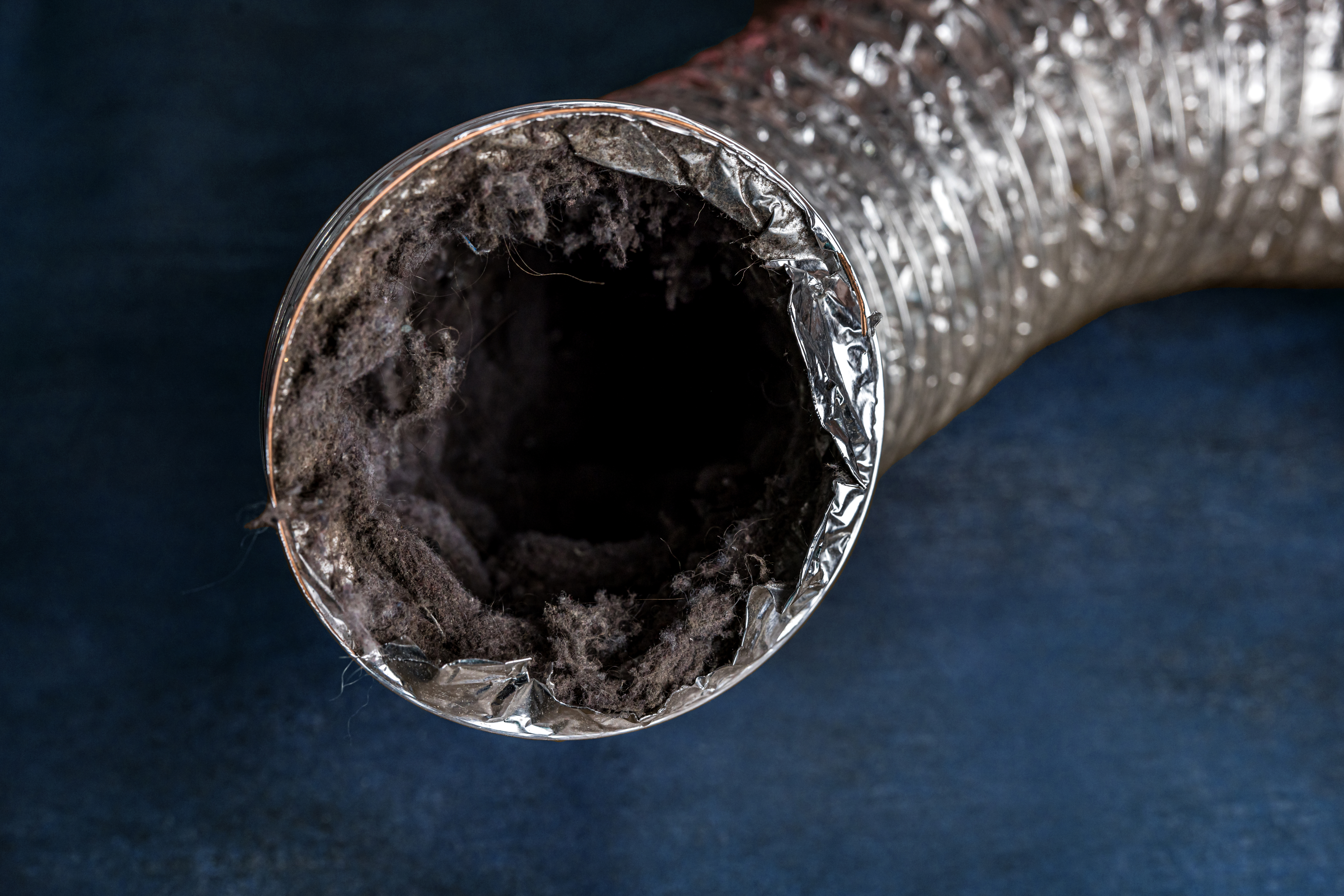 The tube of a dryer vent filled with lint. 
