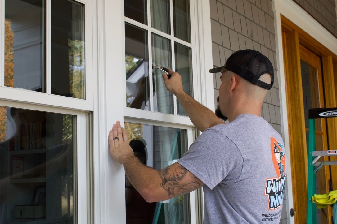 A Window Ninjas technician cleaning the window of a newly constructed home.