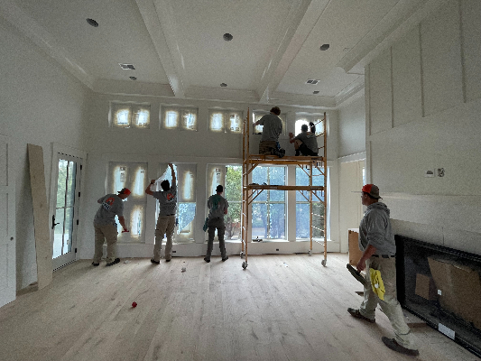 A team from Window Ninjas working on cleaning windows in a post-construction home.