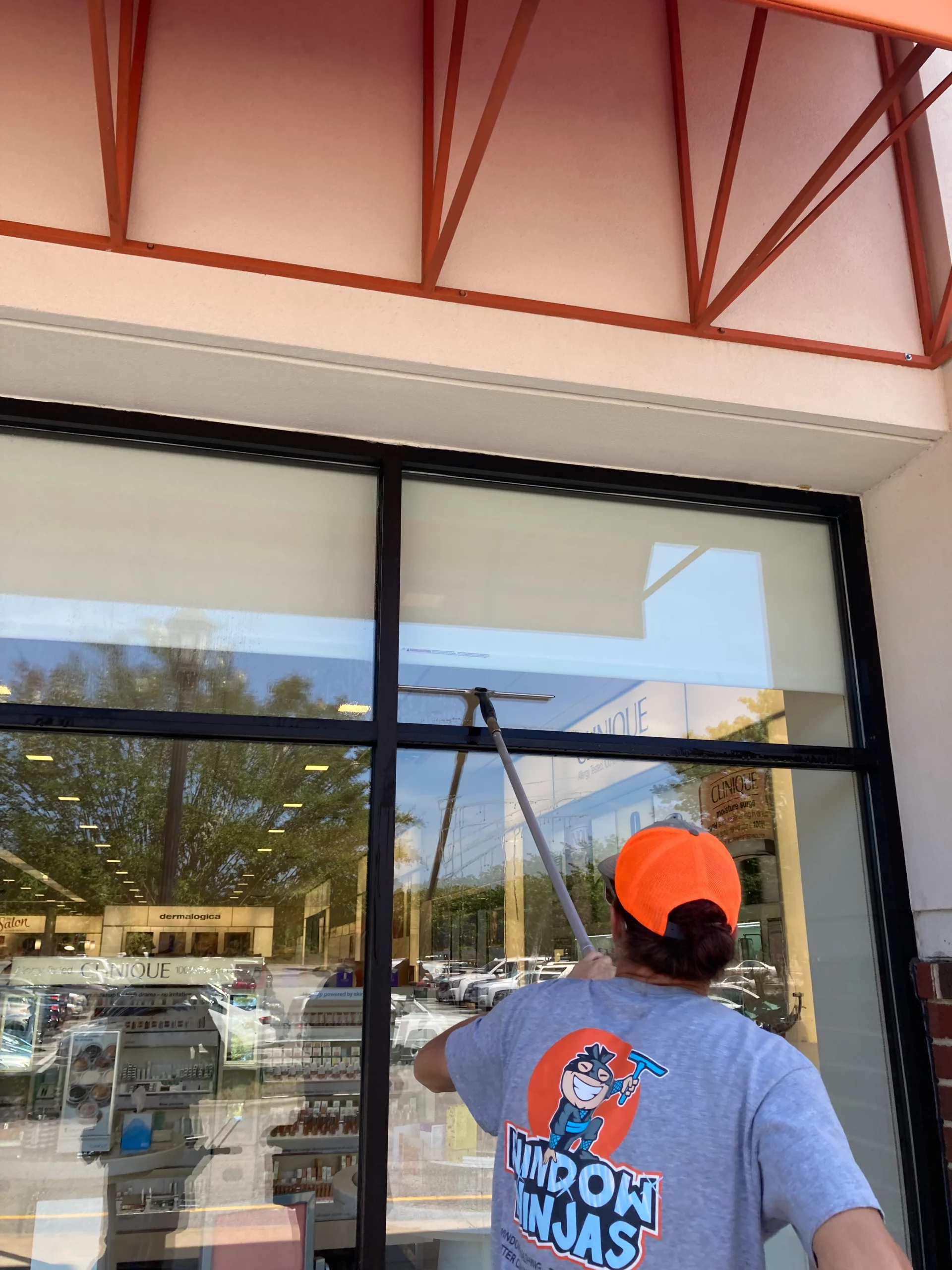 A Window Ninjas professional providing expert cleaning services for a commercial property - experience unmatched commercial window cleaning prices with us.