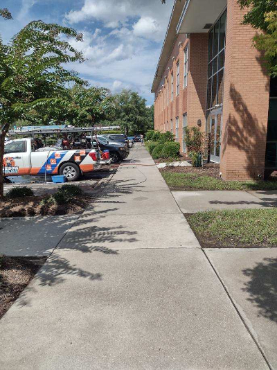 Window Ninjas service trucks in front of a commercial building.