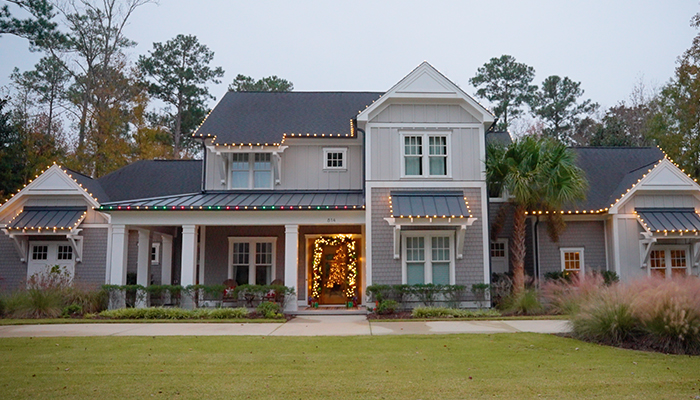 front of house with holiday lights by window ninjas