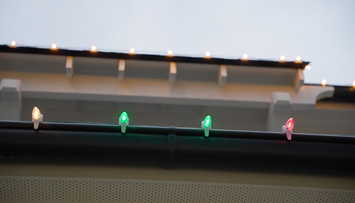 gutter with holiday lights by window ninjas