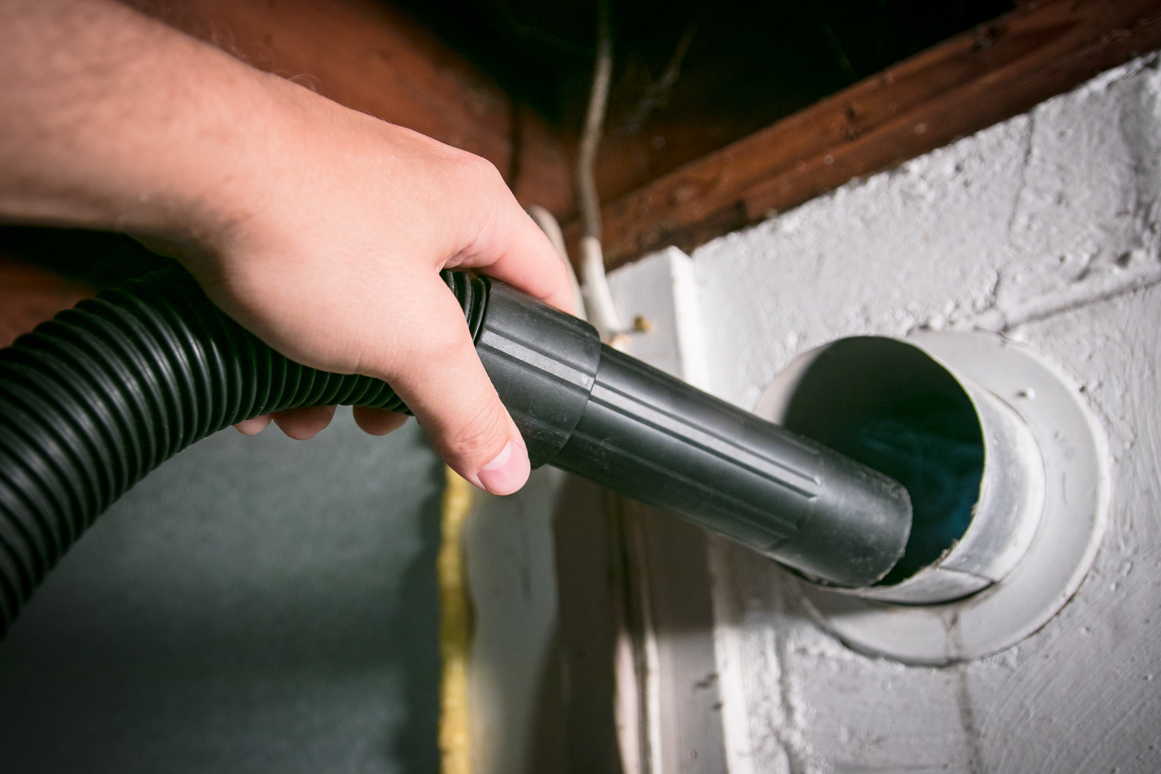 A Window Ninjas technician cleaning a dryer vent - contact us today to find the best price to clean a dryer vent.