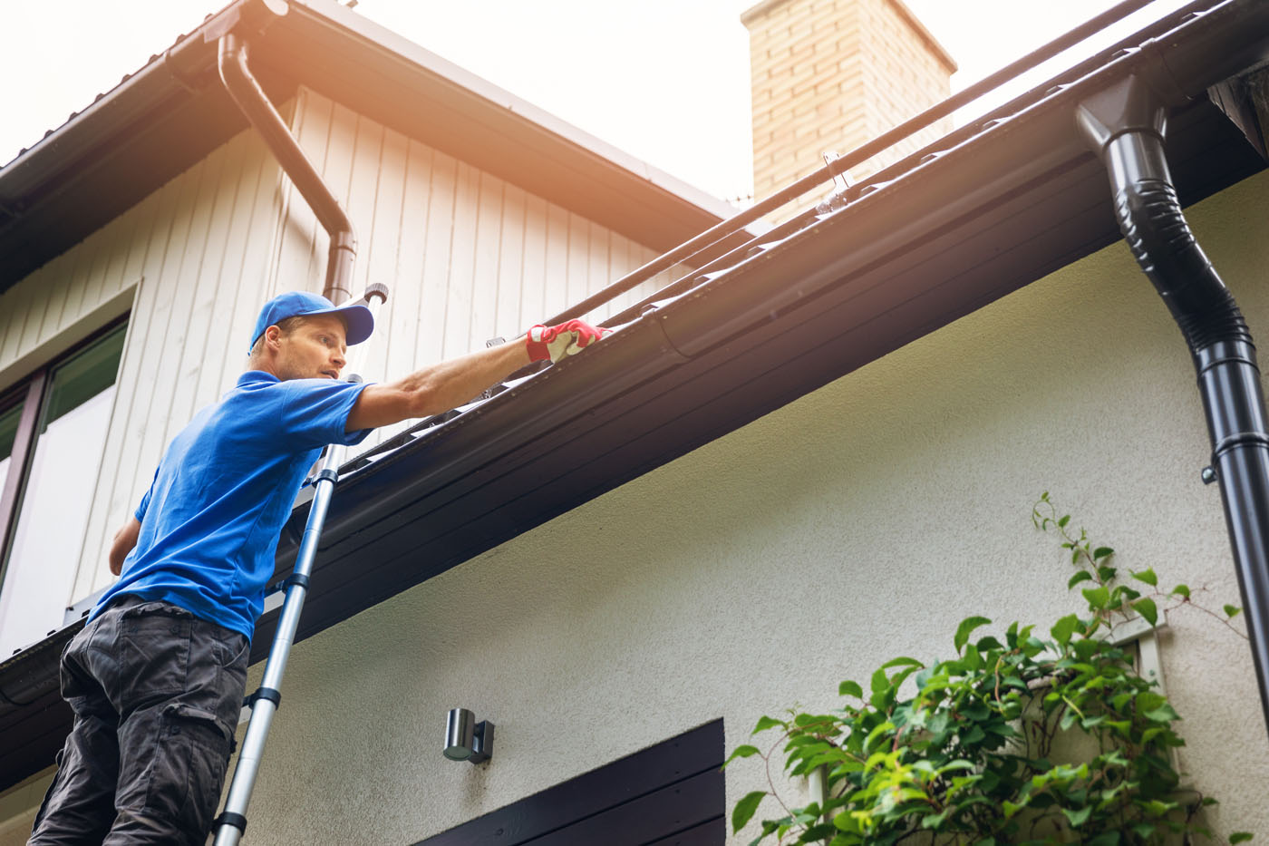 An image of someone cleaning out gutters - Window Ninjas offers the best gutter cleaning.