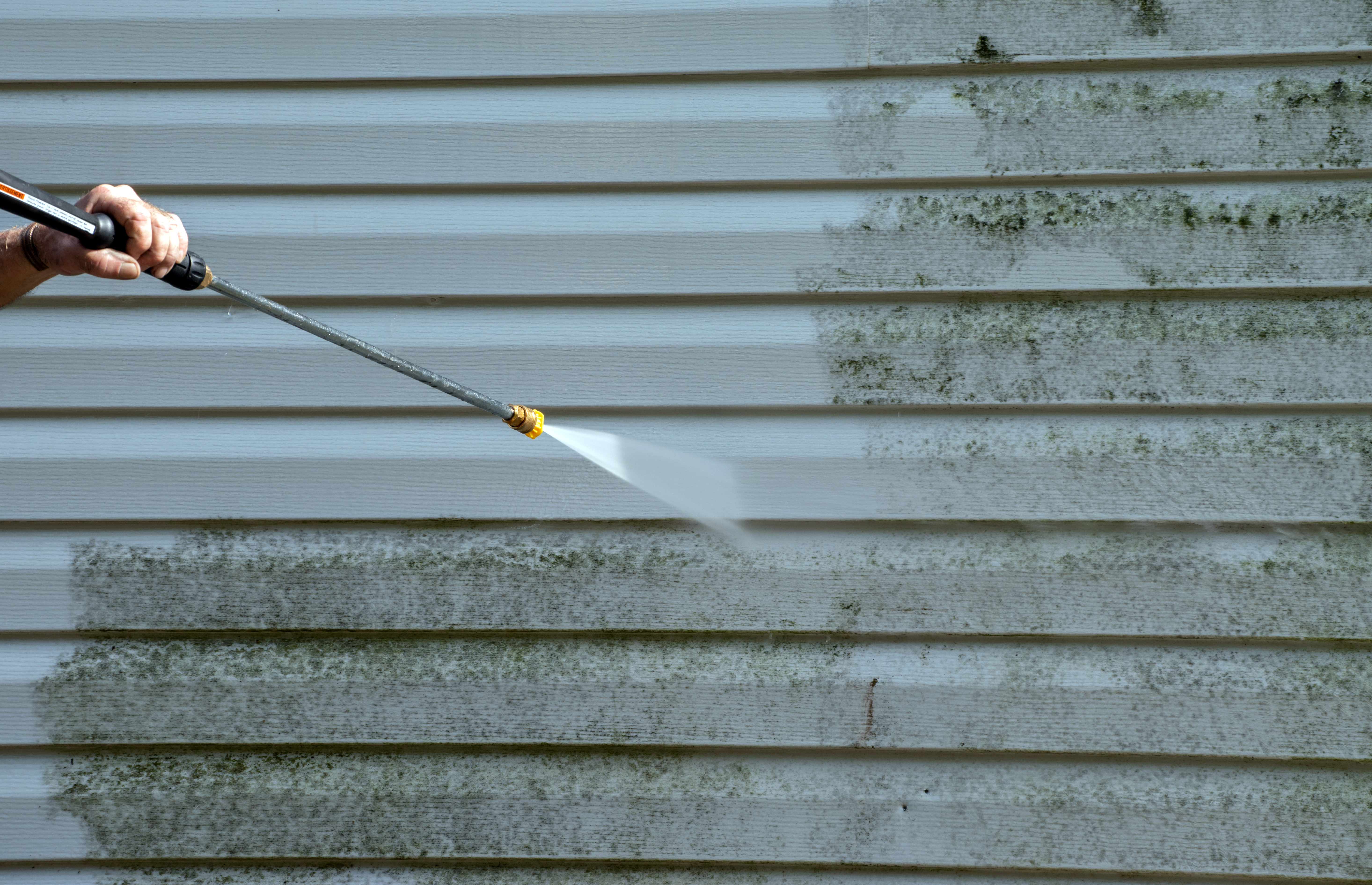 An image of siding pressure washing - Window Ninjas offers services for all types of properties including vinyl siding cleaning.