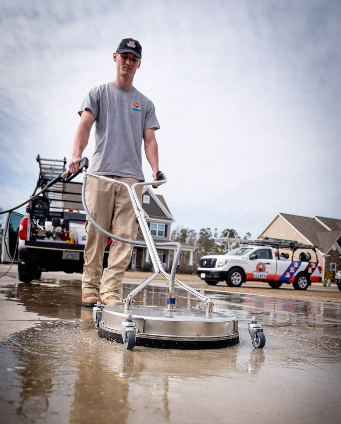 A team member at Window Ninjas providing concrete cleaning services.