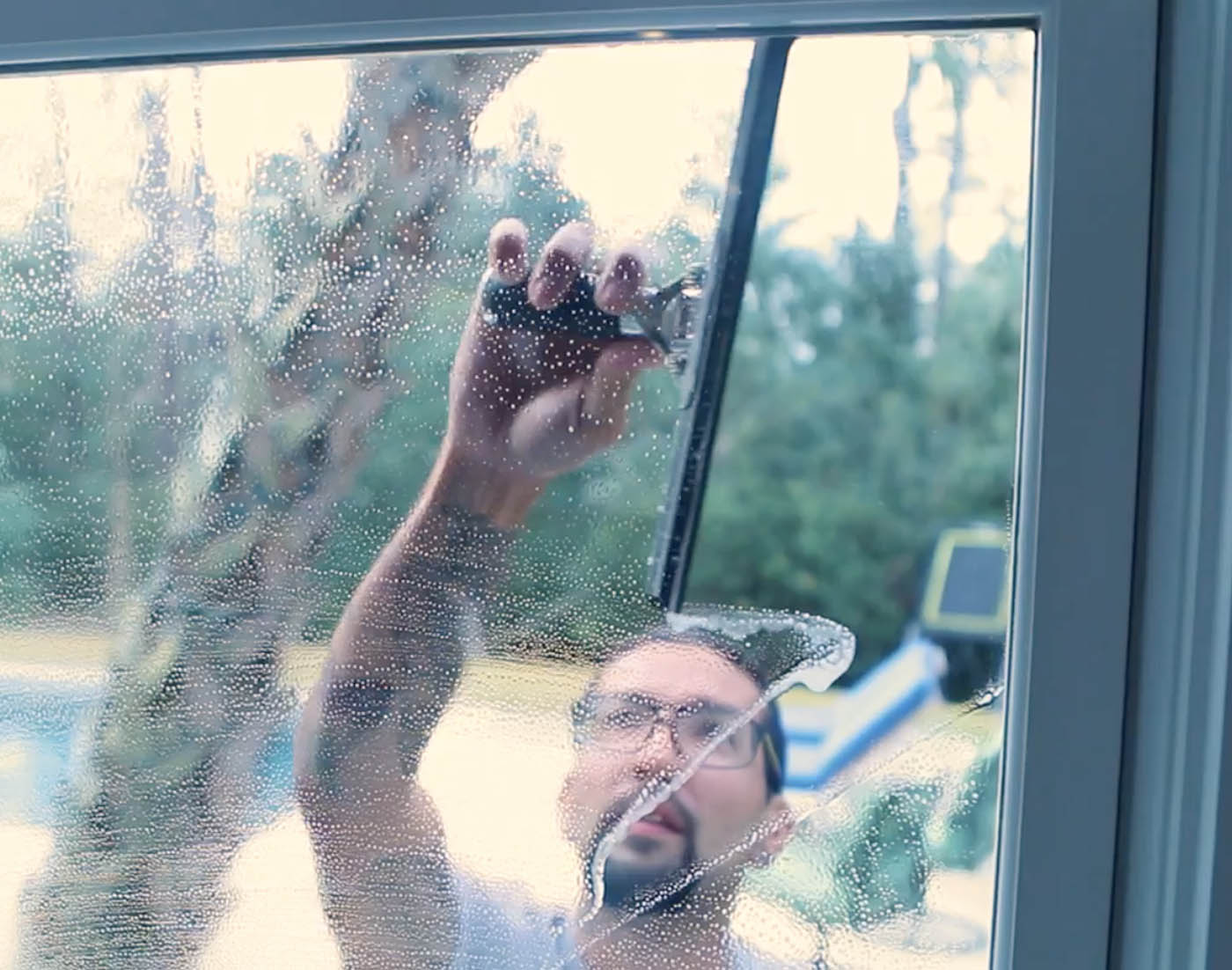 An image of a Window Ninjas technician cleaning a window - contact us today to learn about our post construction window cleaning.