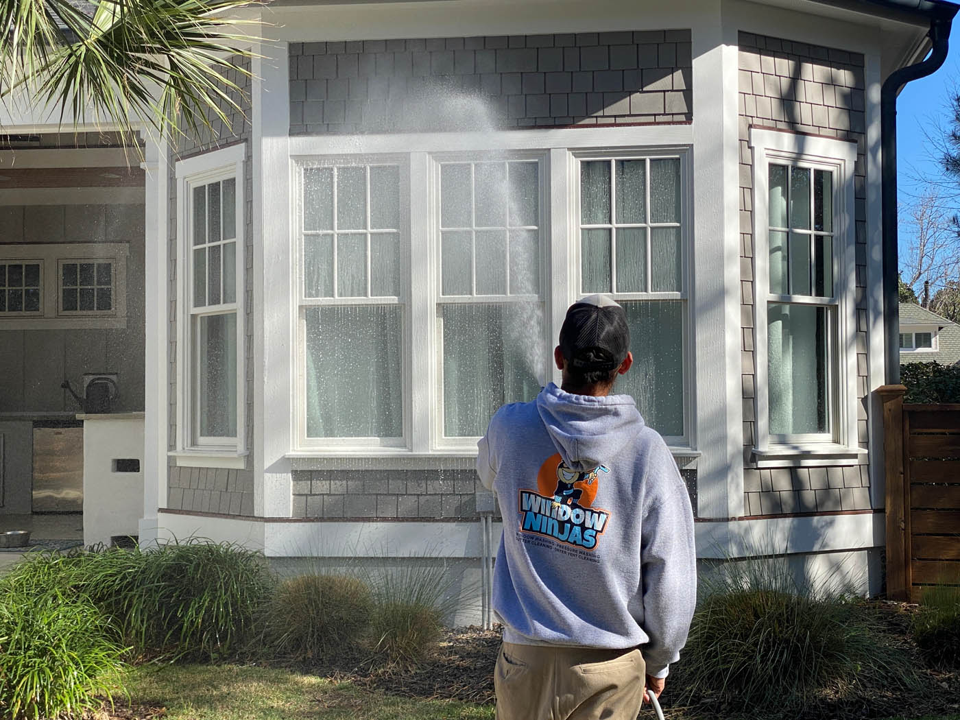 A Window Ninjas professional providing a residential window washing service.